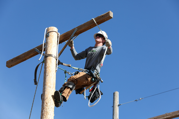 A lineman on a power pole.
