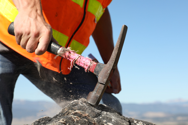 Man hammering a rock