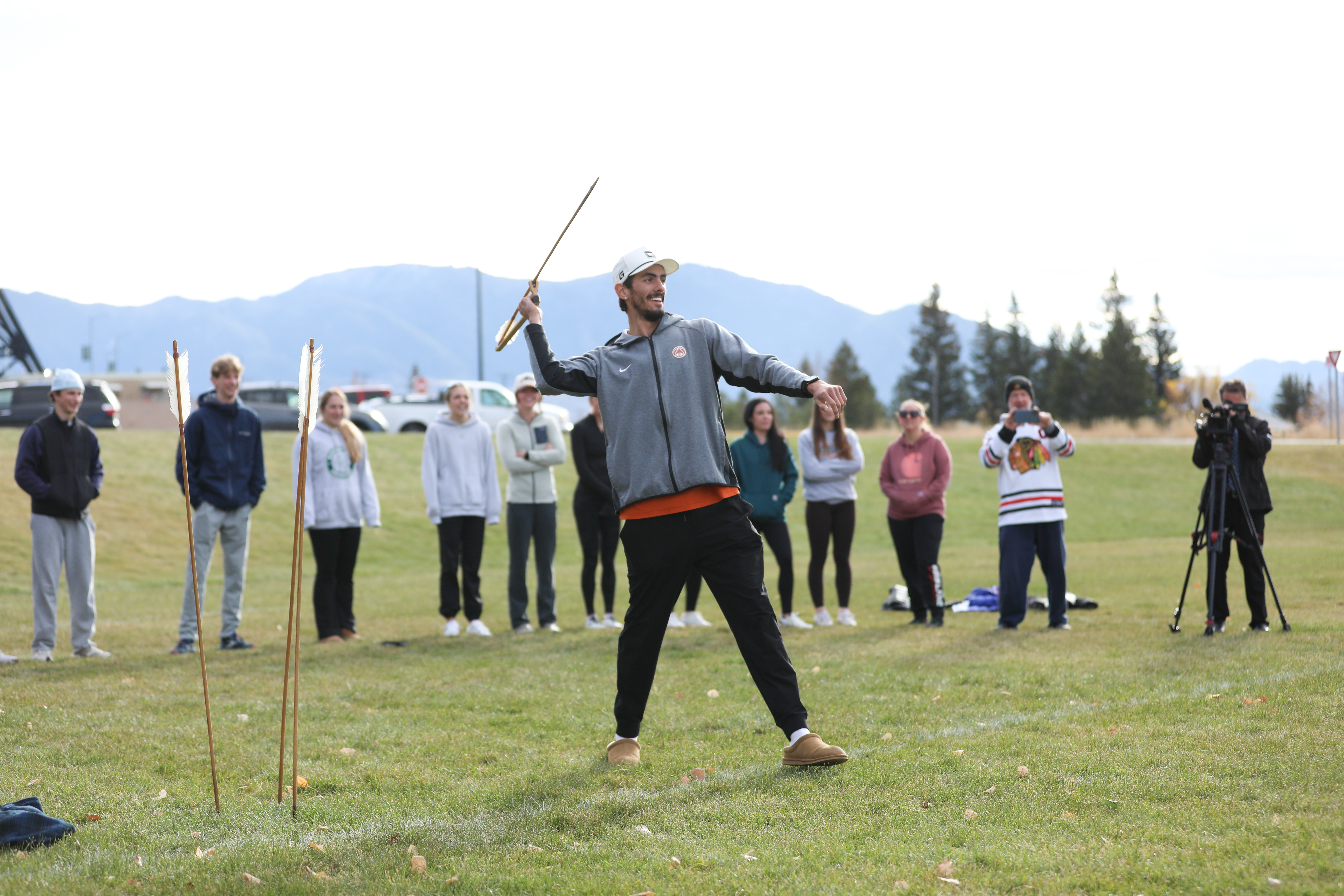 a boy holding a spear-thrower