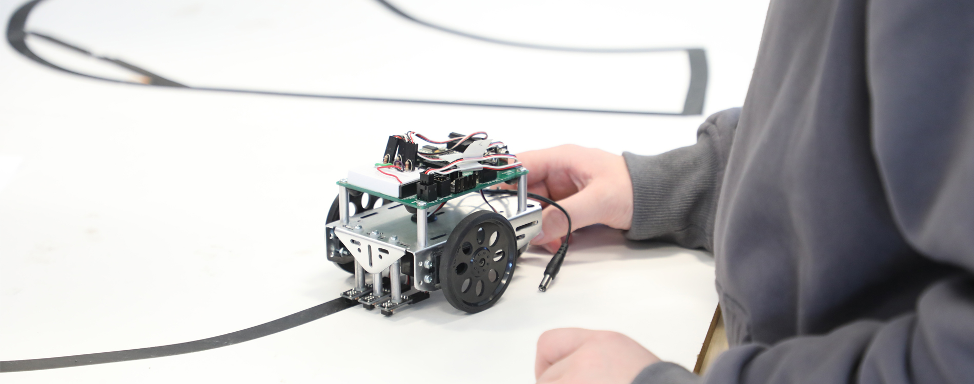 A student walks on campus with Butte in the background. 