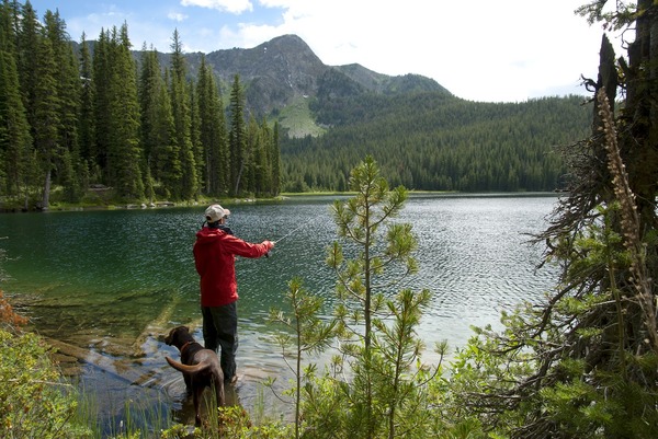 Student and his dog fishing in the mountains.