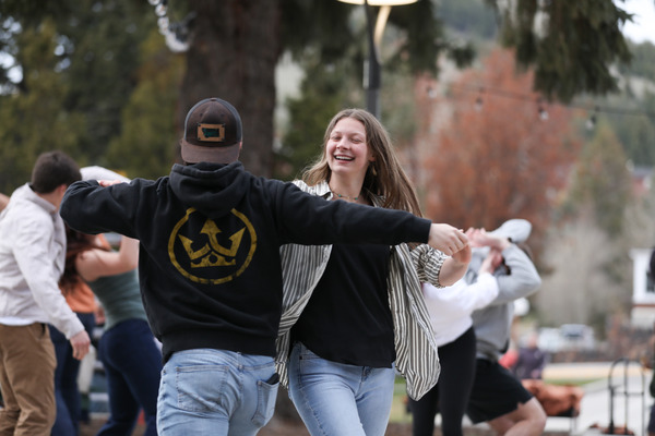 Two students dancing in the courtyard.