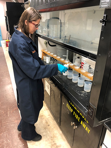 CAMP chemist Tina Stefanescu, conducting acid solubility testing of fracking sand (proppant) expressed as percent of undesirable (non-silica) contaminants.   2