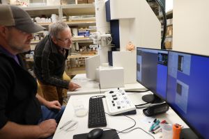 two men looking at computer monitors