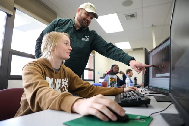 Student and professor in a classroom. 