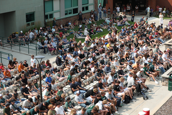 Aerial shot of students at an orientation presentation.