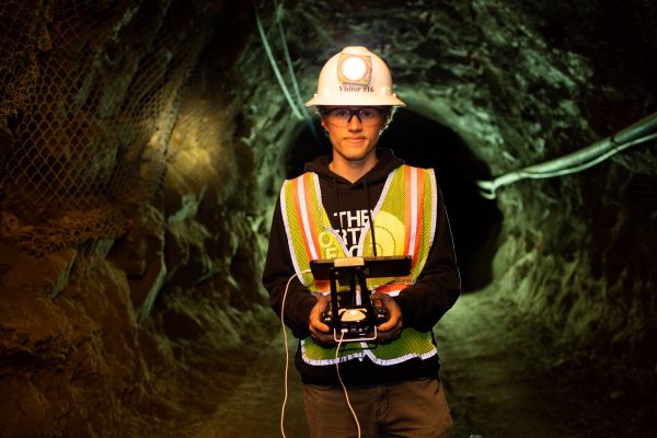 !student operates a drone in underground mining center