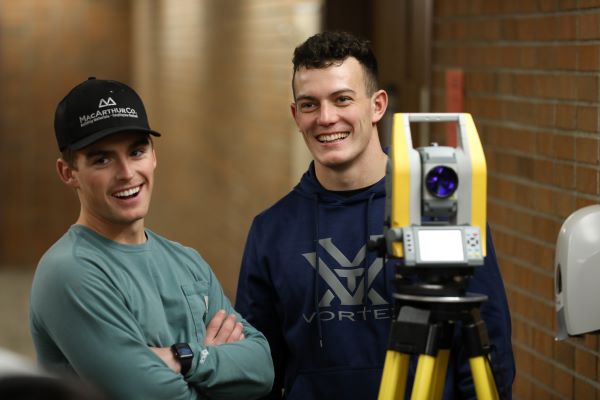 Rutger Shultz and another student smile in a survey class