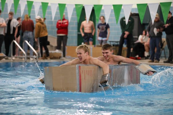 !Students paddle a cardboard boat