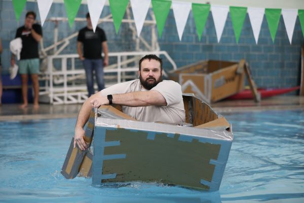 Students paddle a cardboard boat