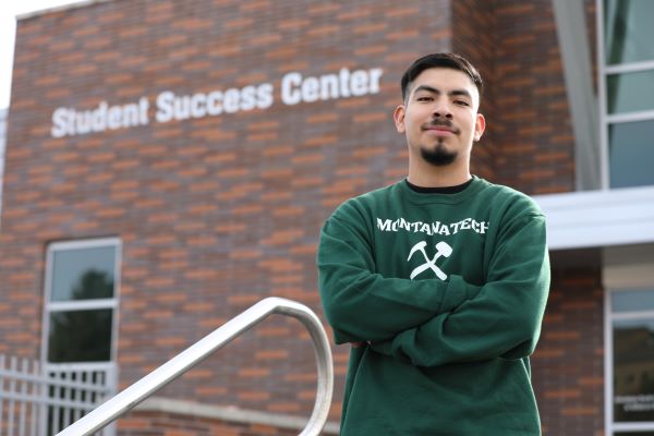 Steven Valencia-Sauno poses for a photo outside of the Student Success Center 