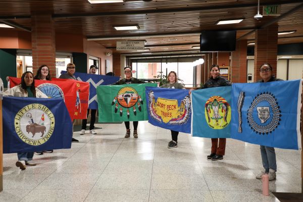 Students hold tribal flags