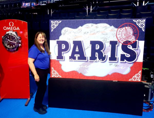 Huckeby with a Paris Olympics sign