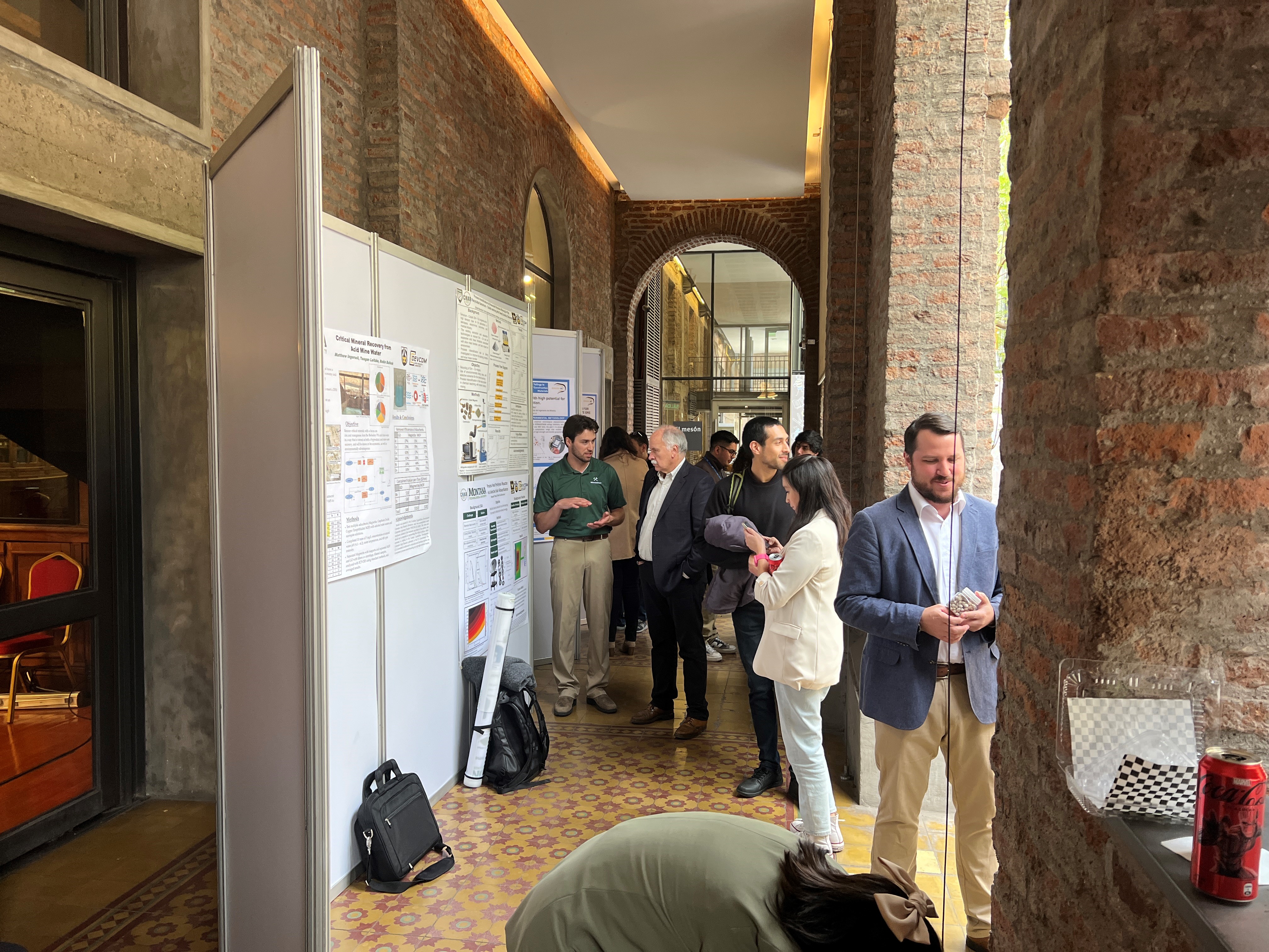 A student exhibits his poster. 