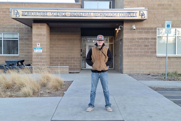 Chase Brown in front of the Beaverhead High School Ag-Science-Industrial technology complex 