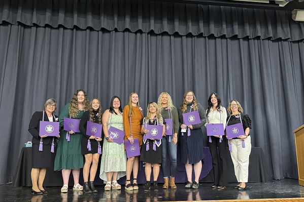 Montana Tech students pose for a photo on the stage.