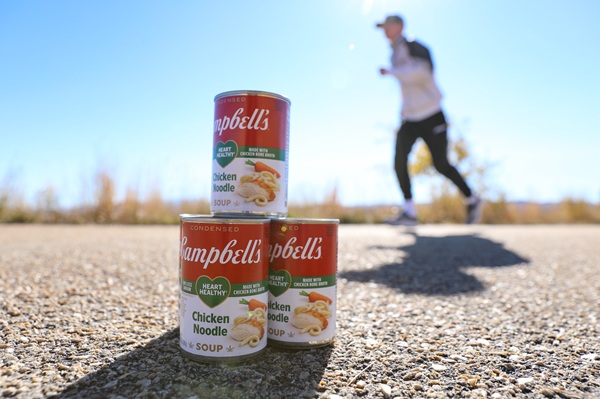 !Cans of soup with a runner dashing behind