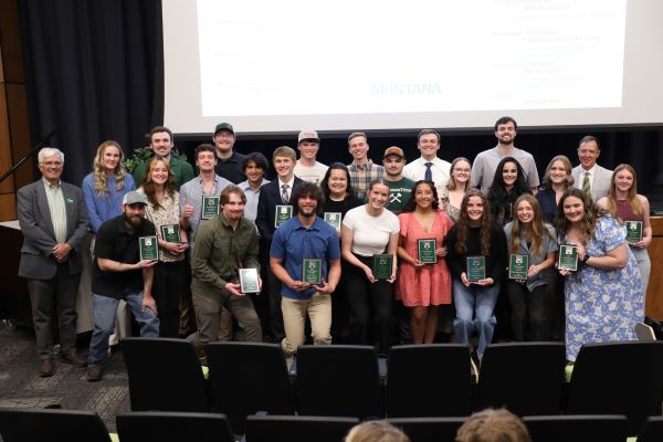 A large group of students pose with their awards
