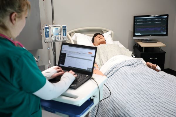 !A student works in the Lesar Family Nursing Simulation Center