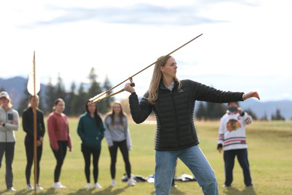 A student throws an atlatl.