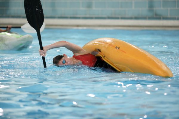 A student rolls a kayak