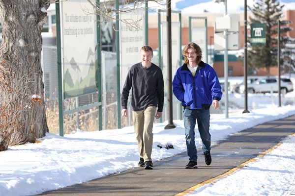 Two students walk in the snow