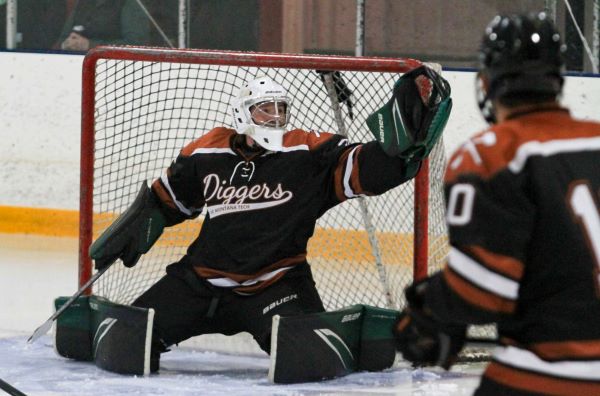 !A goalie catches a puck