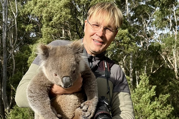 !Ecological restoration professor Dr. Robert Pal holds a koala that he rescued from becoming roadkill.