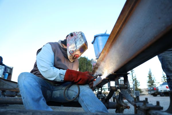 !A welding student works on a trailer