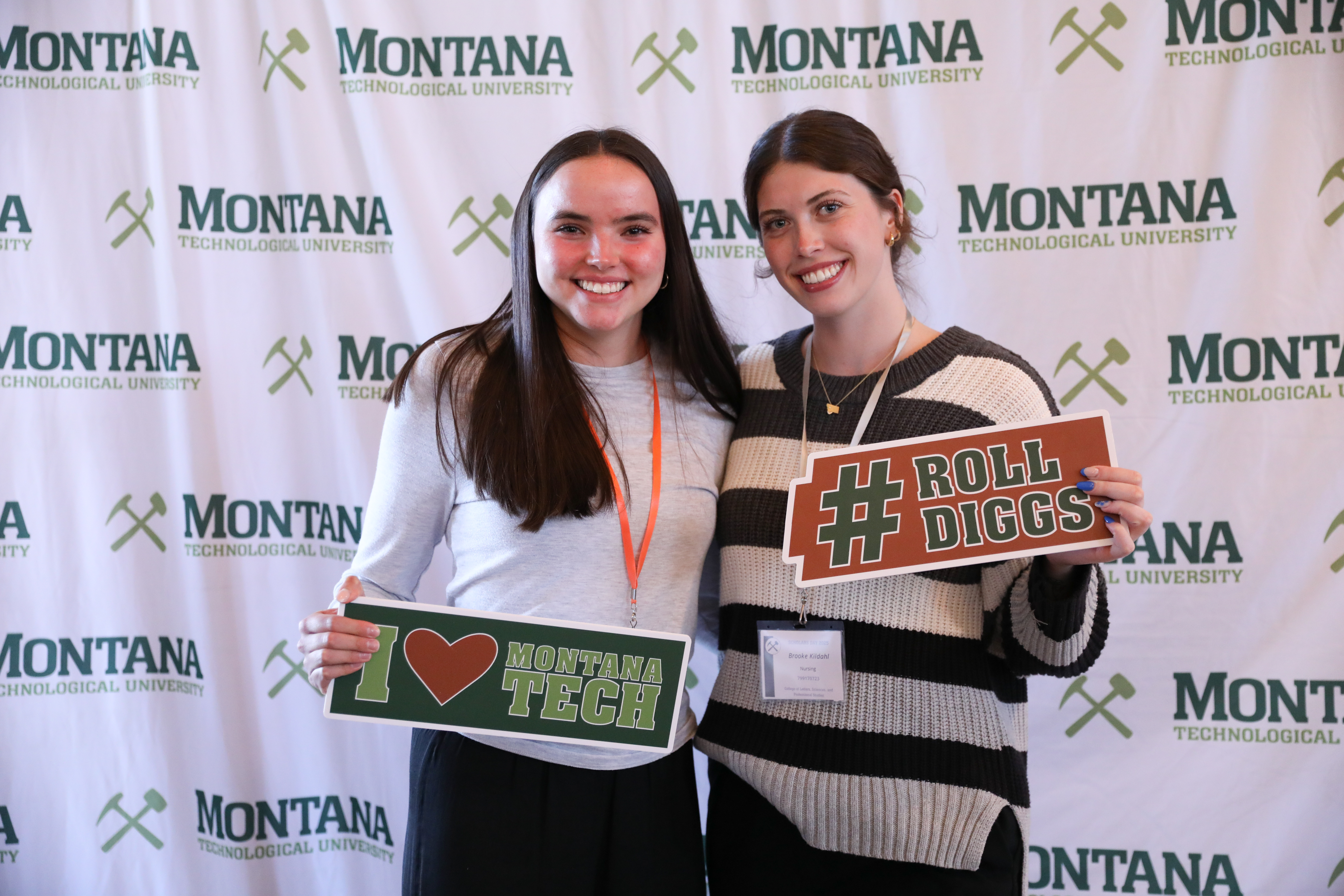 !Two scholarship recipients pose for a phot