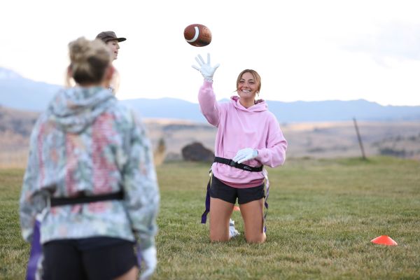 A student throws a football. 