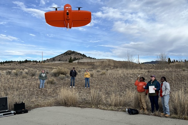 !students watch a drone rise