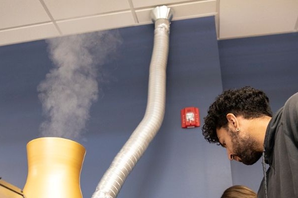 a student works with a model cooling tower 