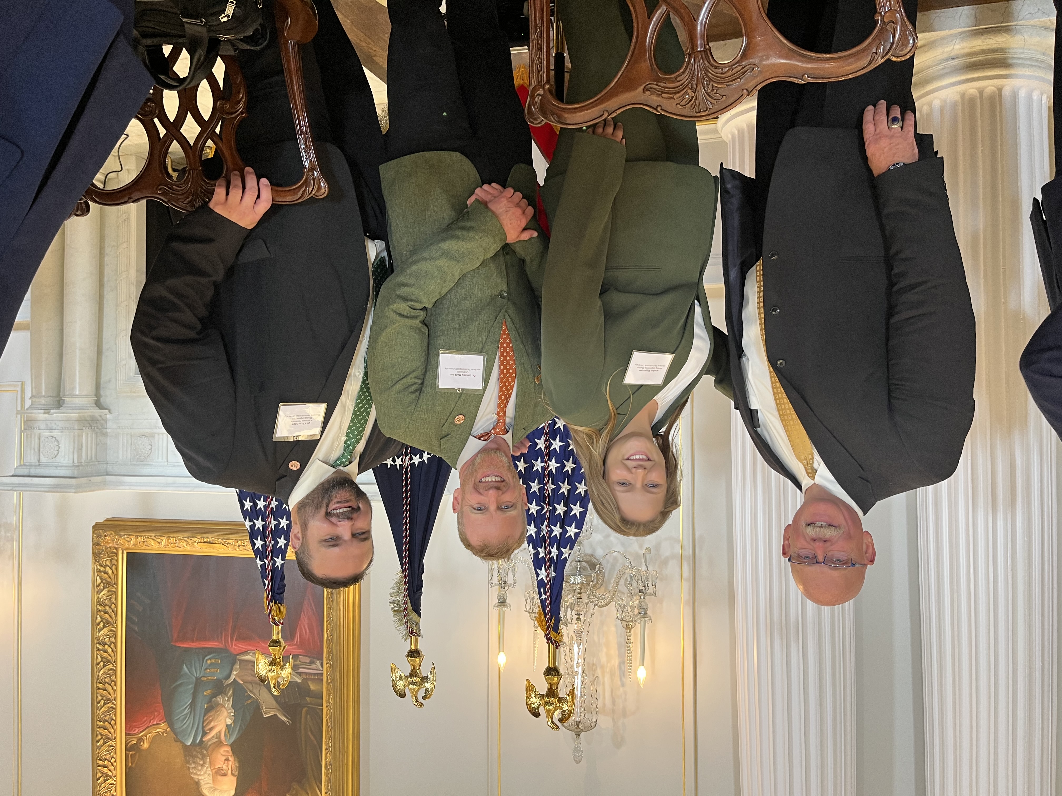University representers standing at the white house