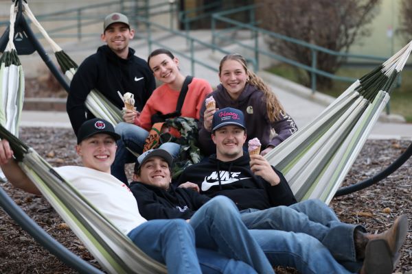 A group of students lounge in hammocks and eat ice cream!