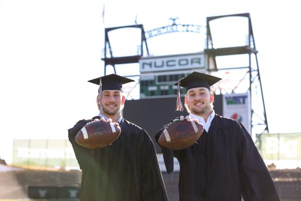 Cade and Cole Wyant on the football field, in camp and gown