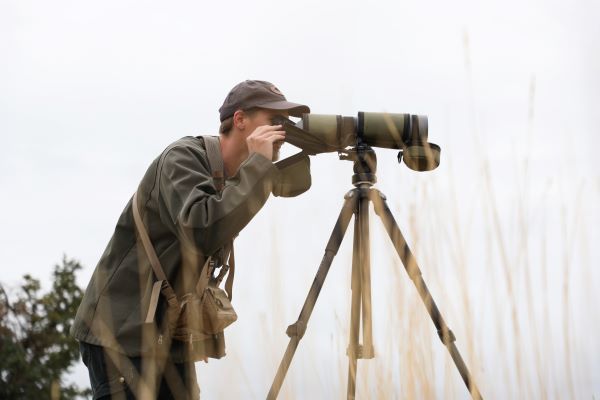 !Caleb Lashway looks through a spotting scope