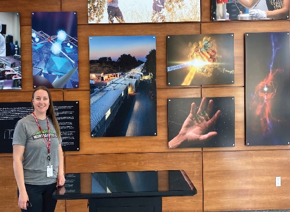 Celine Beacamp poses at a graphic arts display at the synctron facility