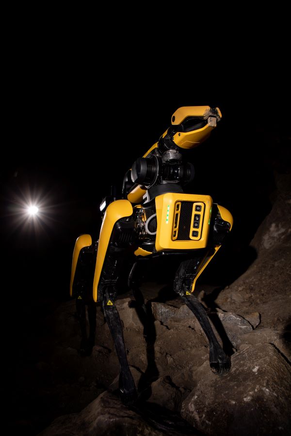 Spot, a Boston Dynamics robot, working in the UMEC with three students