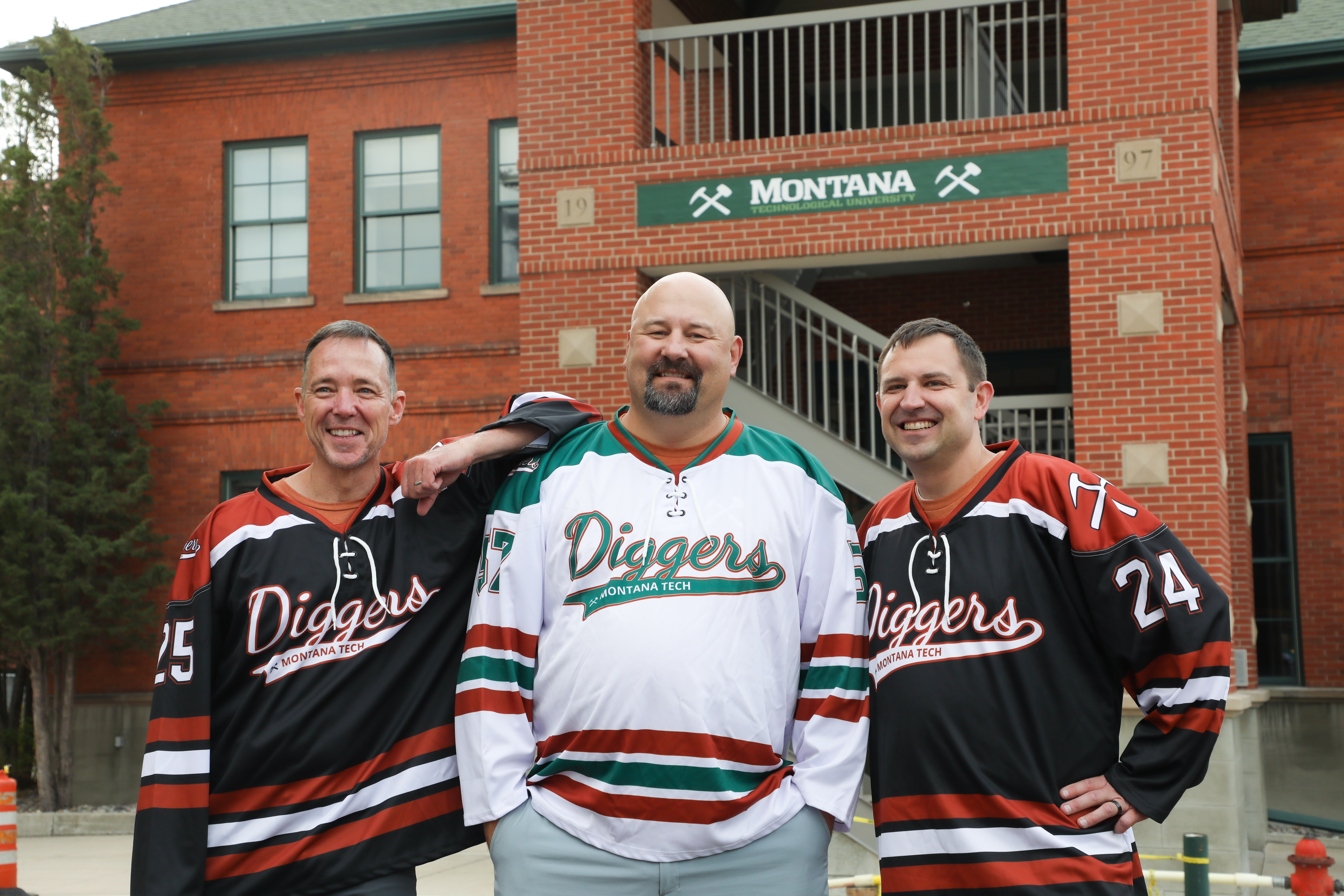 .Chancellor Cook in a hockey jersey with Matt Sepan and Joe Cooper