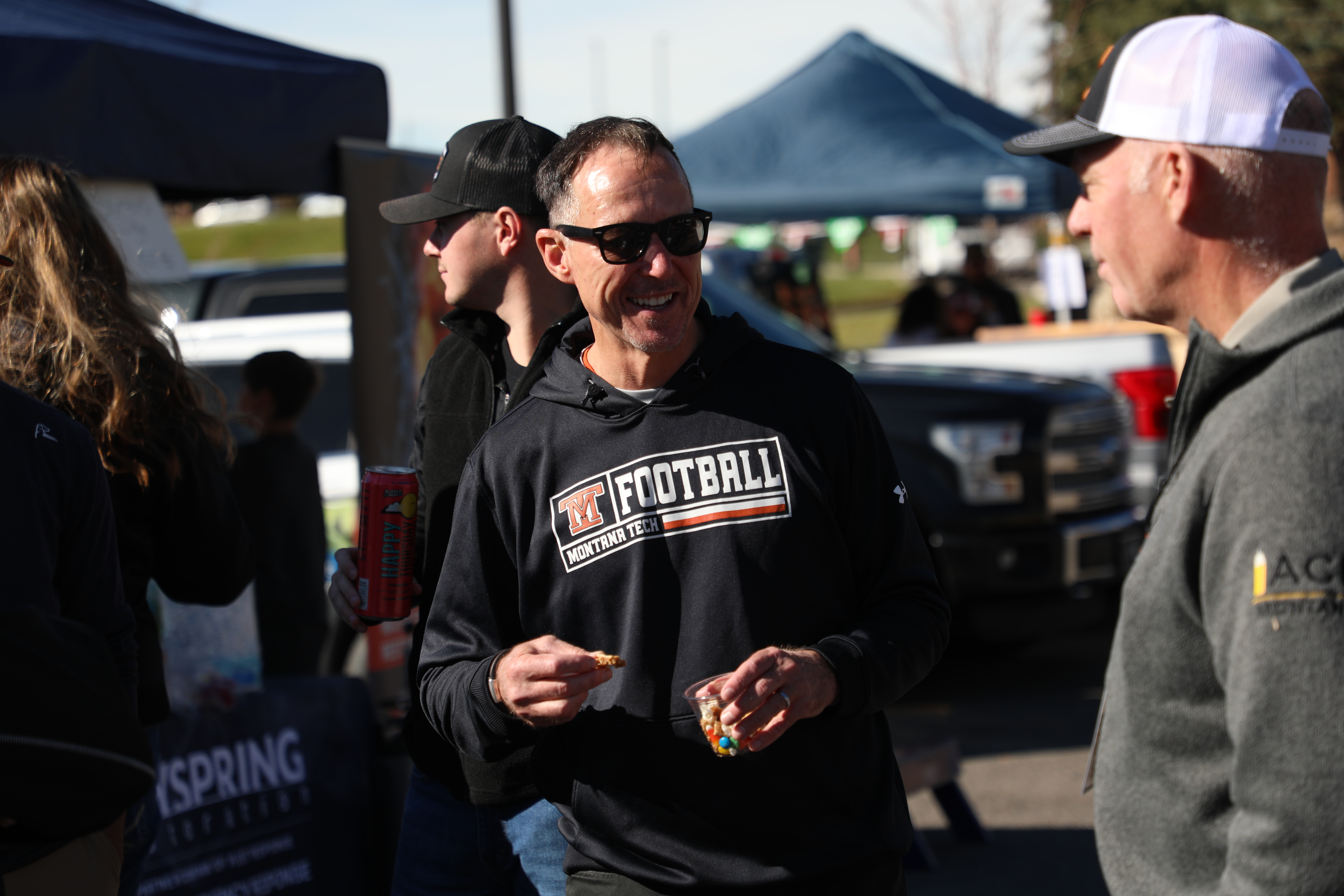Chancellor Cook speaks with someone at a football game