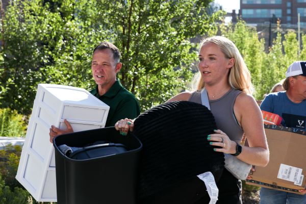 Chancellor Cook helps a student move in