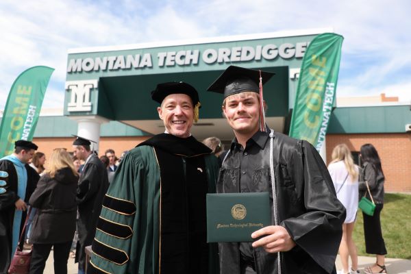Chancellor Cook poses with a student at graduation