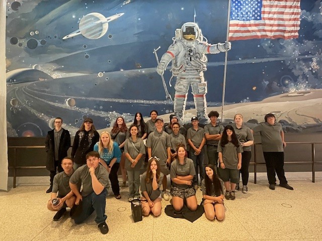 Students in front of an astronaut mural